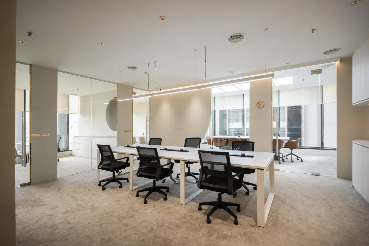The shared workspace establishes scale and daily function without visual clutter.
