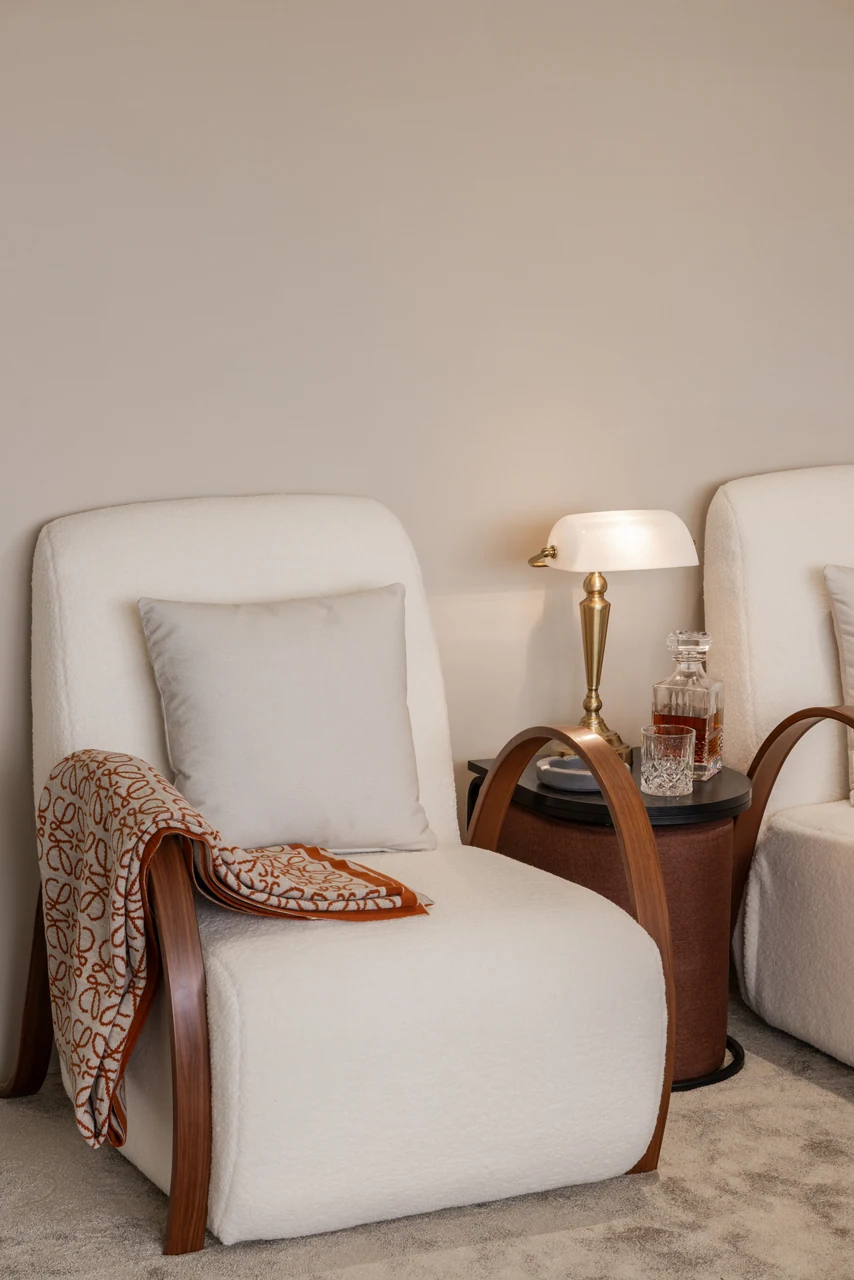 Soft upholstery and timber arms add tactile warmth between wider views.