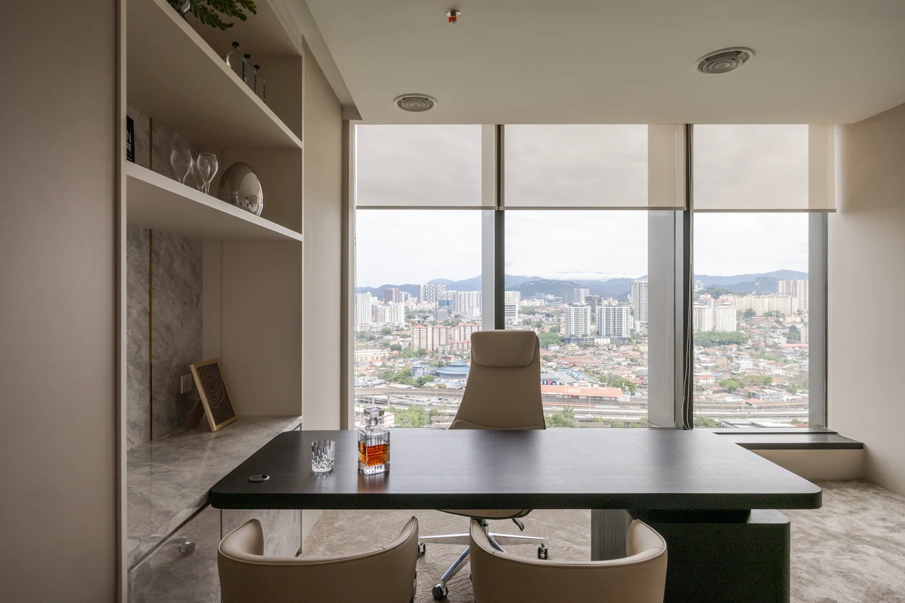 A frontal desk composition anchors the office to its city outlook.