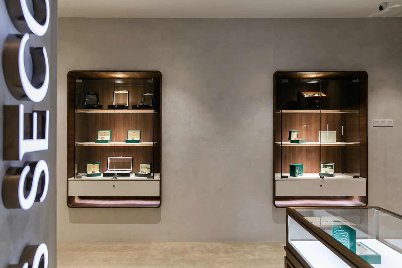 Two framed showcases and the sign edge reveal the display system clearly.