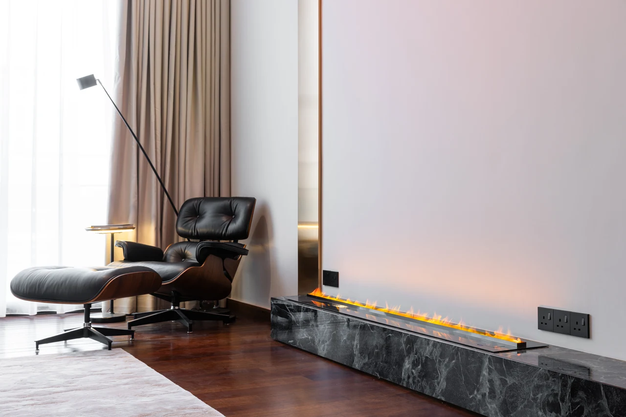 The lounge chair, stone plinth and brass strip tell a specific material story.