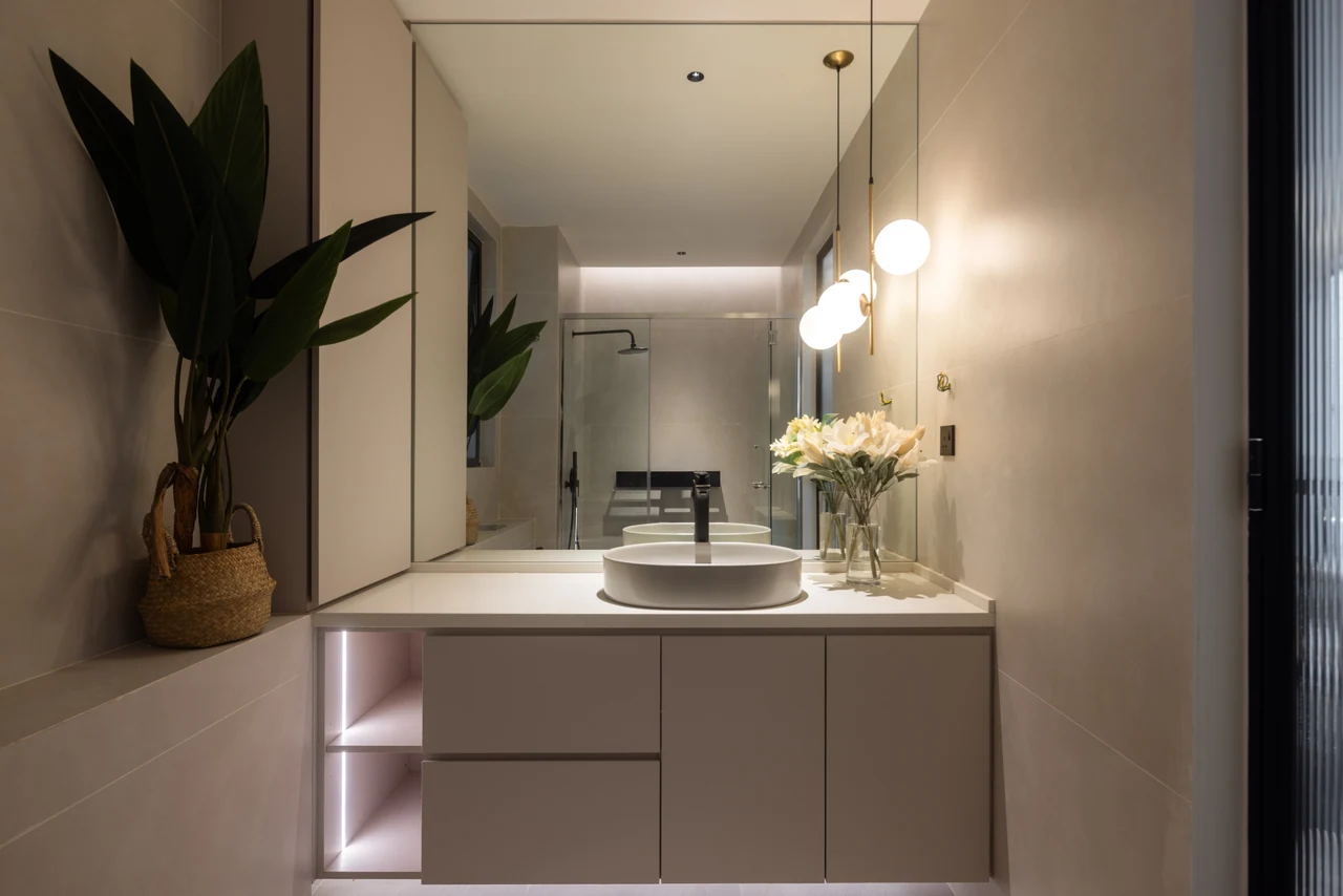The brighter vanity adds a distinct bathroom view and prevents the sequence becoming uniformly dark.