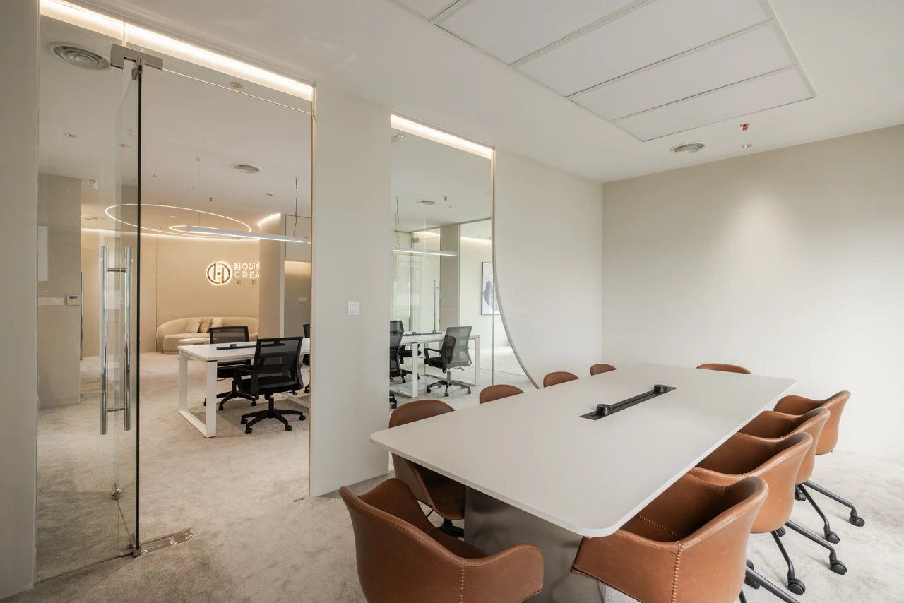 An oblique meeting-room view shows the glazing and connection to the wider office.