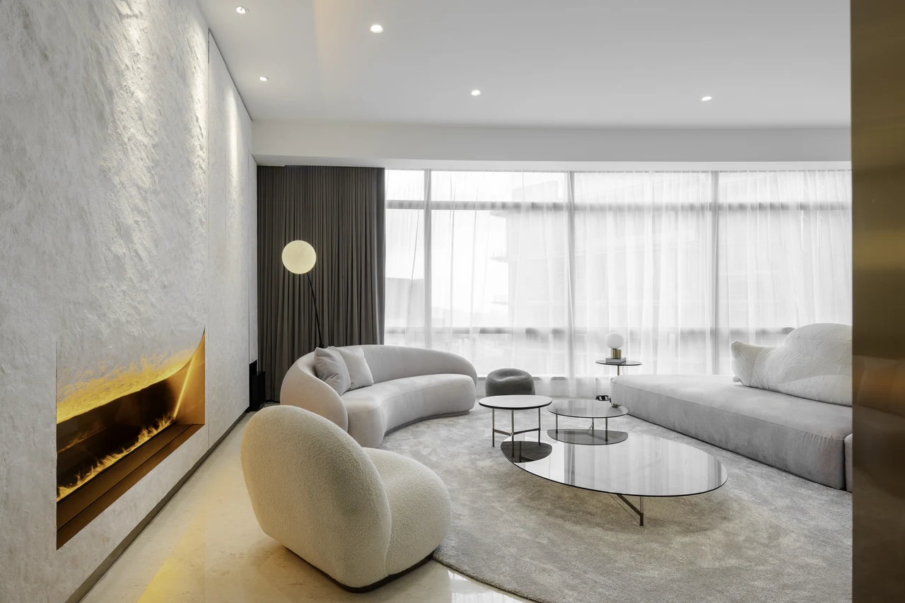 Textured stone, circular brass shelving and a dark bar.