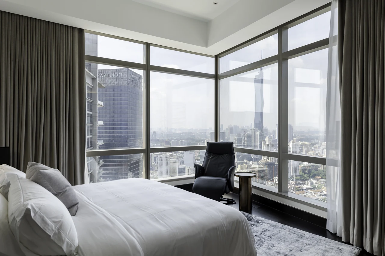 Corner glazing and the skyline explain the principal bedroom’s spatial value.