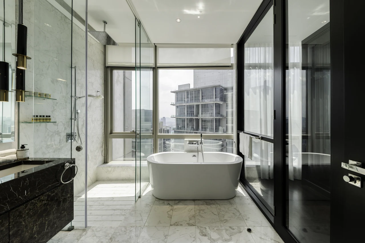 The freestanding bath centred on the window offers a clear architectural bathroom image.