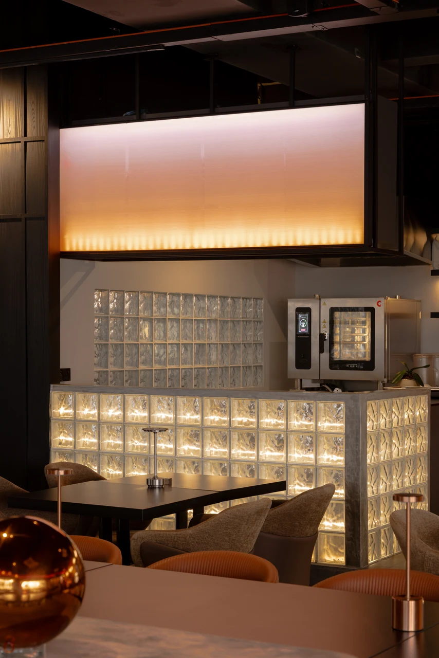 The softly lit bar panel provides a controlled vertical composition.
